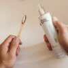 ORL toothpaste with bamboo brush tight shot with hands